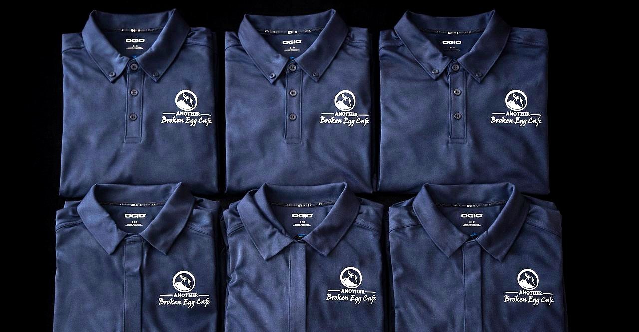 Folded embroidered polo shirts produced by MugsLab