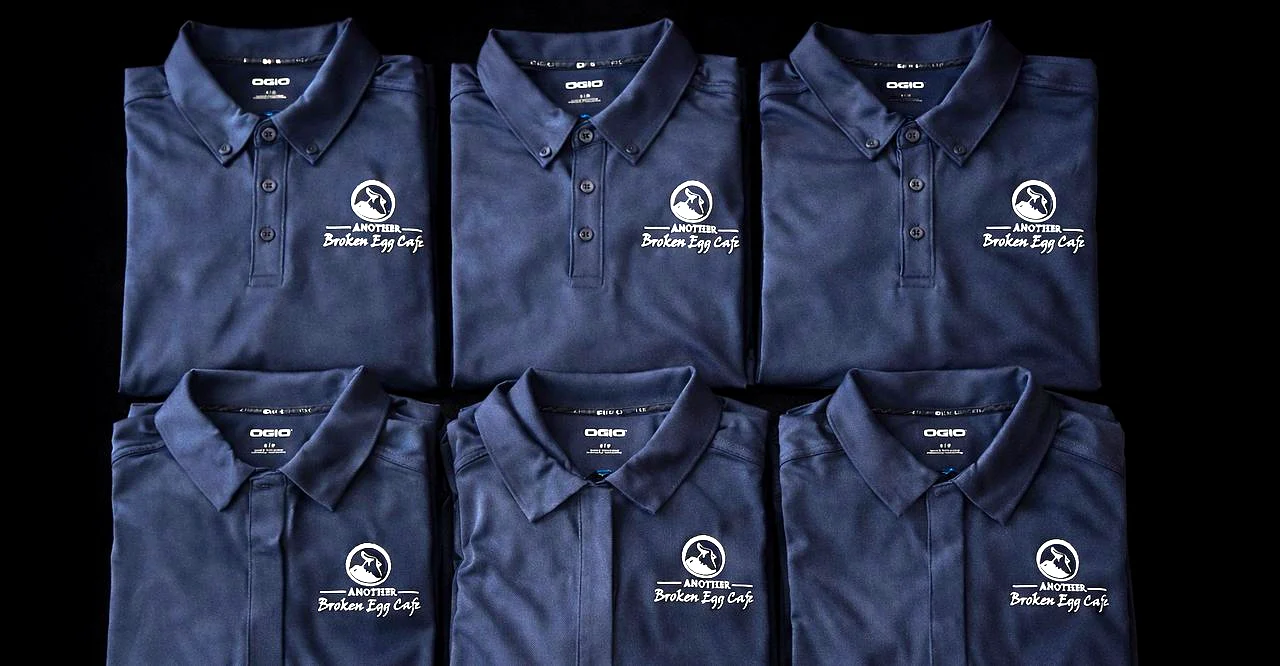 Folded embroidered polo shirts produced by MugsLab